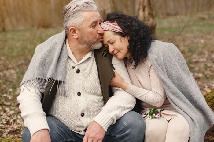 Man kissing woman sitting together